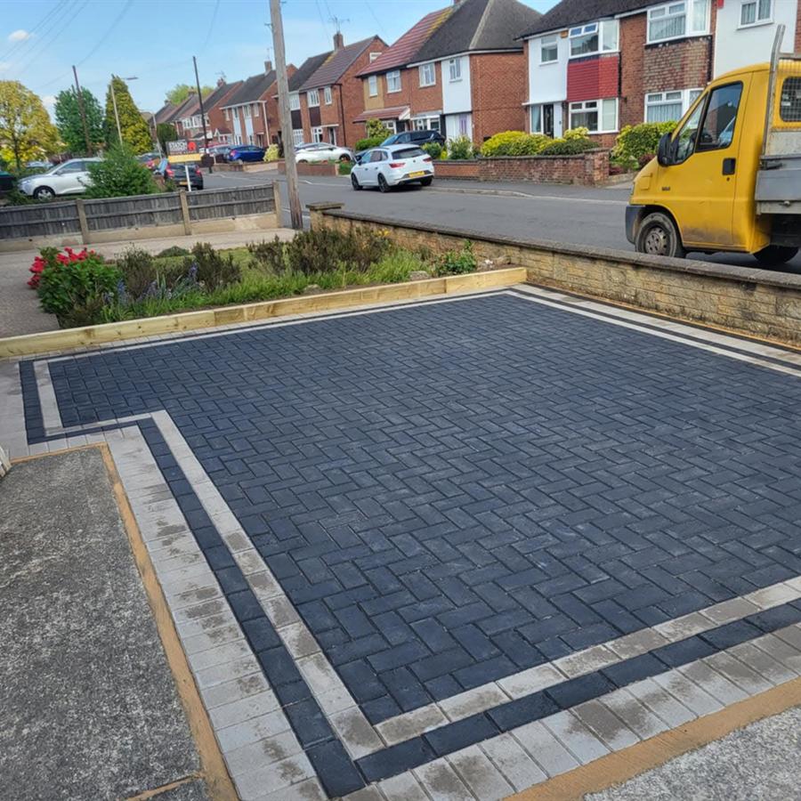Charcoal block paving driveway with kerb
