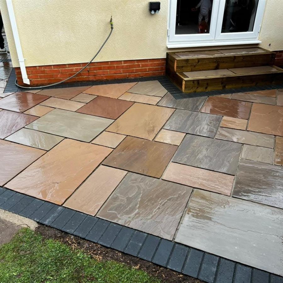 Riven sandstone patio with charcoal border