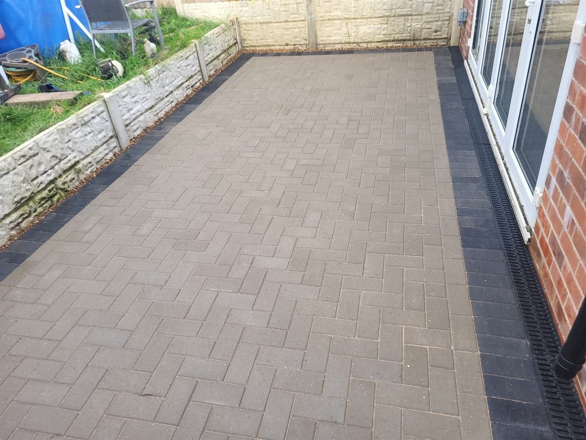 Retaining wall and block paving in front of patio doors