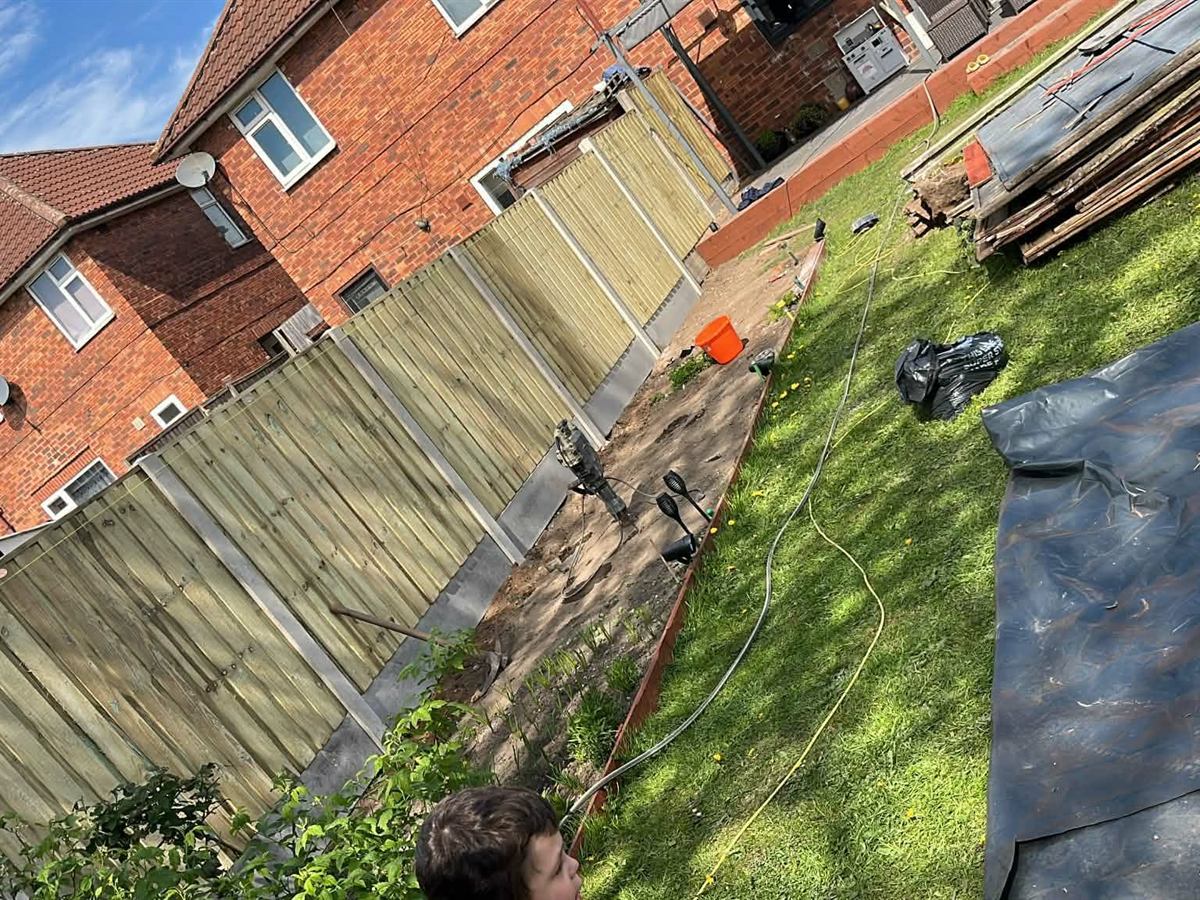 New close-board fence panels along a garden boundary