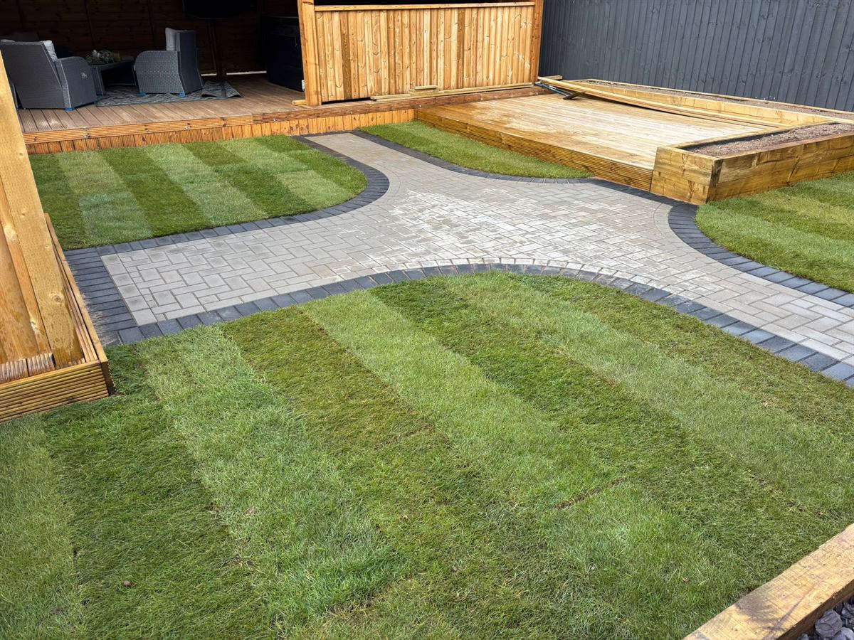 Garden transformation with a shaped lawn and a paved path