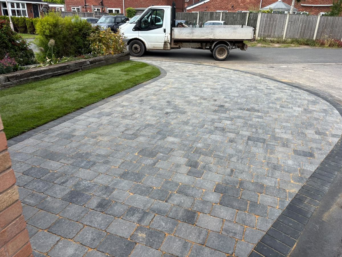Finished block paved driveway with a curved lawn edge